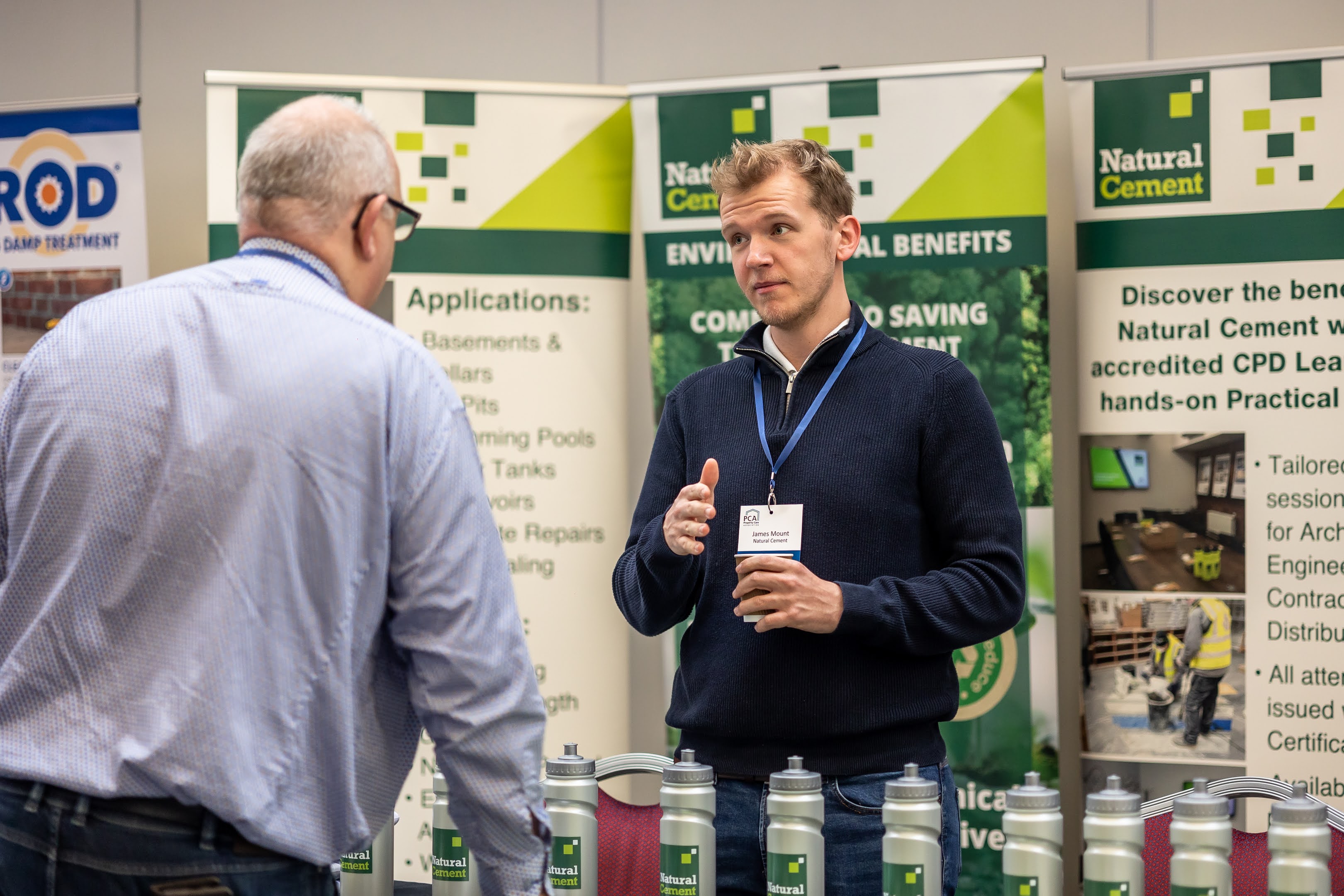 James Mount speaking with an attendee at an industry event